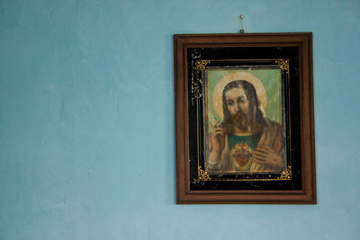 Low angle view of statue by window on wall