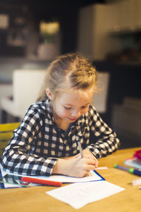 Close-up of girl studying at table