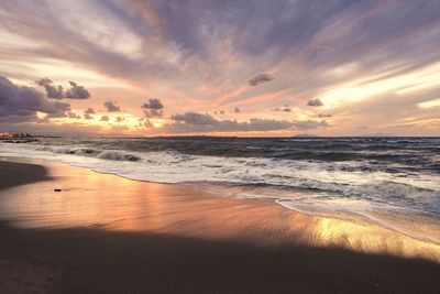 Scenic view of beach against sky during sunset