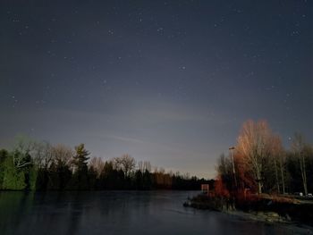 Scenic view of lake against sky at night