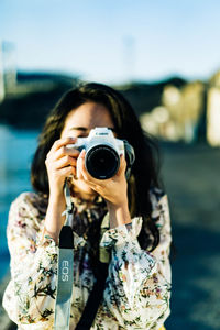 Portrait of woman photographing