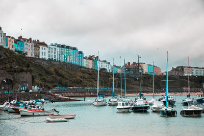 Boats moored on sea against sky