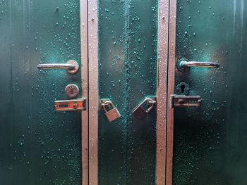 The condition of an unlocked door in an employee rest area after rain.