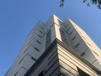 Low angle view of modern building against clear blue sky