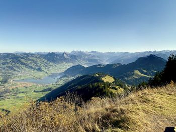 Scenic view of mountains against clear blue sky