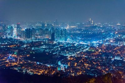 Aerial view of city lit up at night