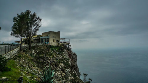 Building by sea against sky