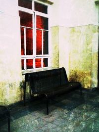 Empty chairs against brick wall