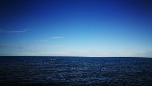 Scenic view of sea against blue sky