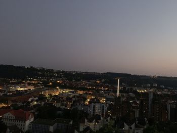 High angle view of illuminated city against sky at dusk