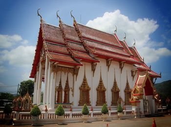 Low angle view of temple against cloudy sky