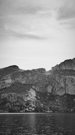 Scenic view of sea and mountains against sky