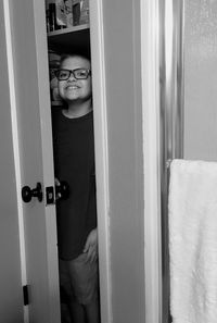 Portrait of boy standing by door