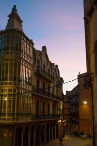 Low angle view of illuminated building against sky