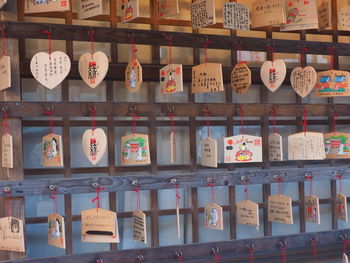 Close-up of religious text on woods hanging at temple