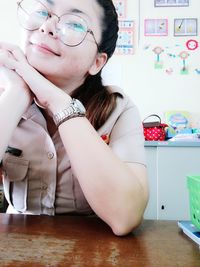 Portrait of female police officer sitting at desk