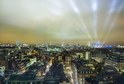 High angle view of illuminated buildings against sky at night