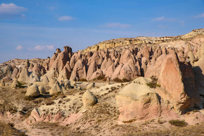 Rock formations on landscape against sky