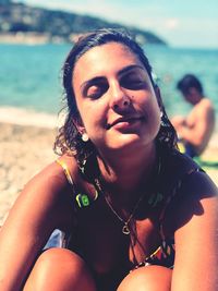 Portrait of young woman sitting on beach