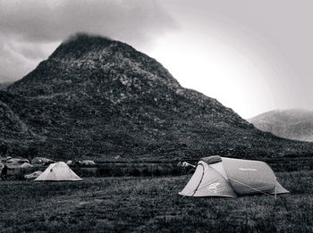 Scenic view of tent on mountain against sky