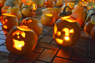 Illuminated jack o lanterns on footpath at night