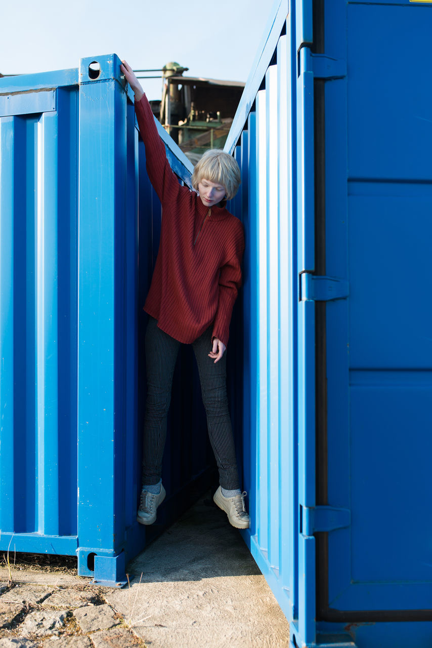 Woman between shipping containers