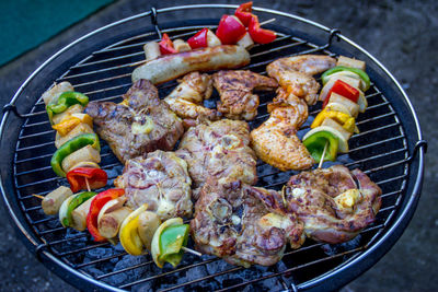 High angle view of meat and vegetables on barbecue