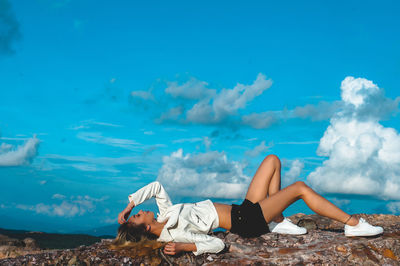 Side view of woman lying on rock