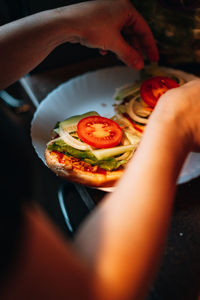 Close-up of hand holding pizza