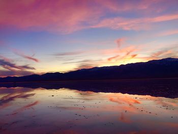 Scenic view of lake against romantic sky at sunset