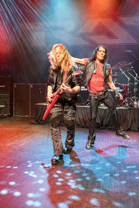 Women standing on illuminated stage