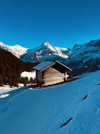 Scenic view of snowcapped mountains against clear blue sky