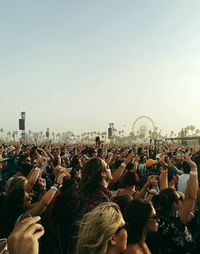 People enjoying at concert against clear sky