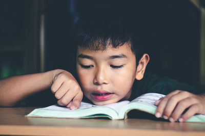 Close-up portrait of boy on table