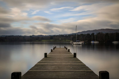 Pier over lake against sky