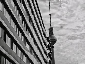 Low angle view of buildings against cloudy sky