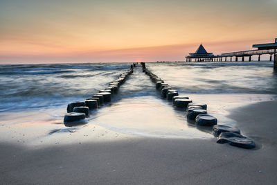 Scenic view of beach against sky during sunset