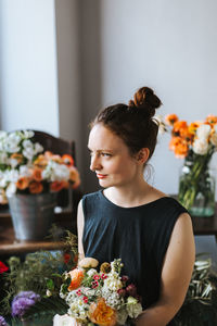 Woman looking at flower bouquet