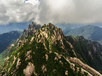 Scenic view of mountains against cloudy sky