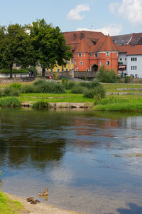 Scenic view of lake by building against sky