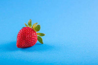 Close-up of strawberry against blue background