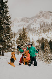 Couple in love and dogs playing in the snow