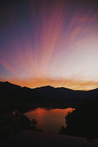 Scenic view of lake against romantic sky at sunset