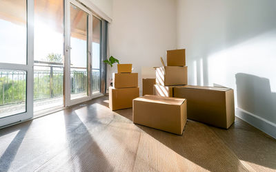 Moving boxes stand in an empty apartment, ai generates