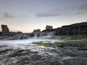 Scenic view of waterfall against sky. beautyful klayar beach, indonesia