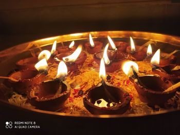 High angle view of lit candles on birthday cake