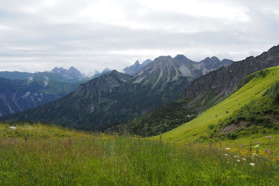 Scenic view of mountains against cloudy sky