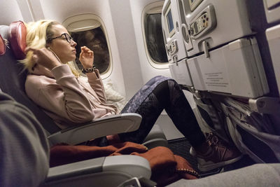 Mid adult woman sitting at airplane