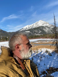 Portrait of man on snowcapped mountains during winter
