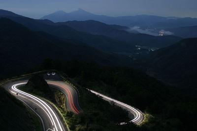 High angle view of light trails on road at night